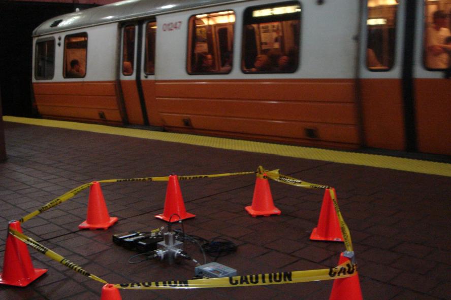 Floor vibration testing equipment on ground near subway car
