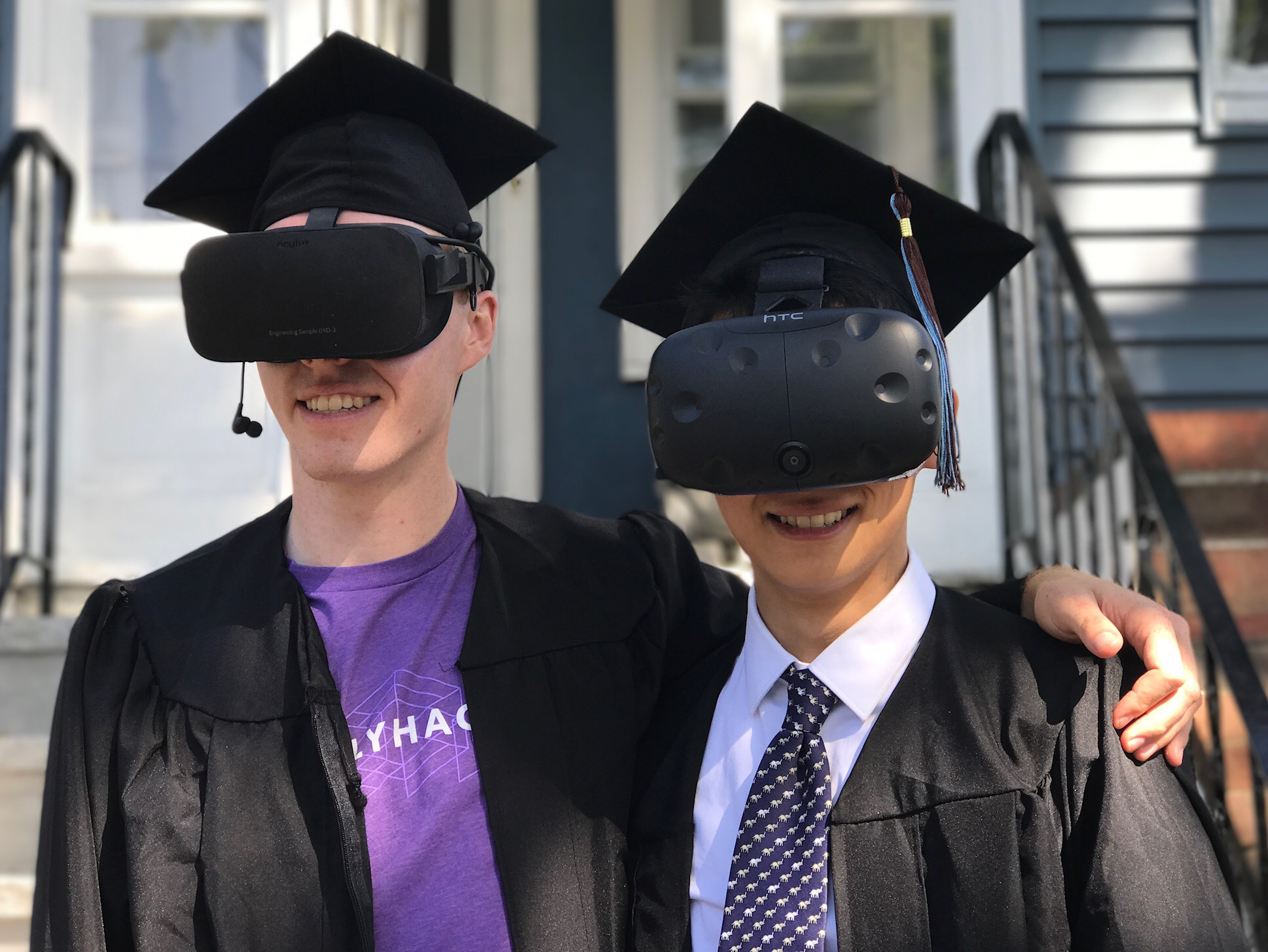​ Jeremy Slavitz and Henry Zhou wearing VR goggles on graduation day. ​