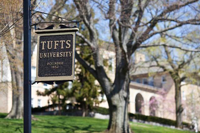 Tufts sign in front of a tree