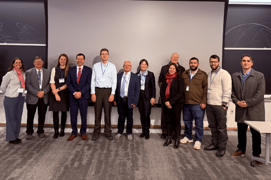 Attendees of the conference pose for a photo in the lecture hall.