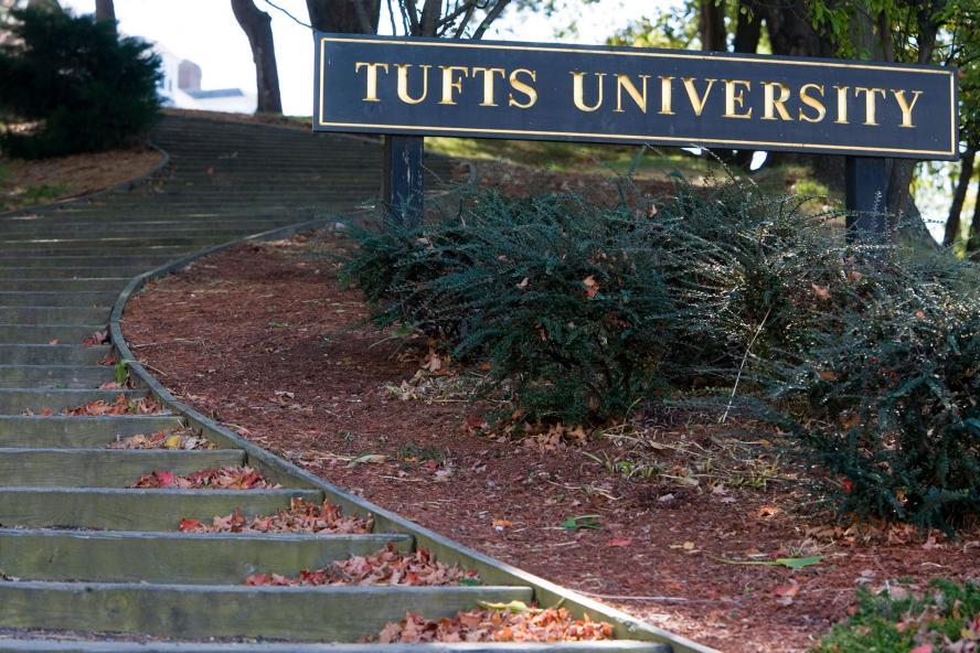 Tufts University sign by outdoor stairs.