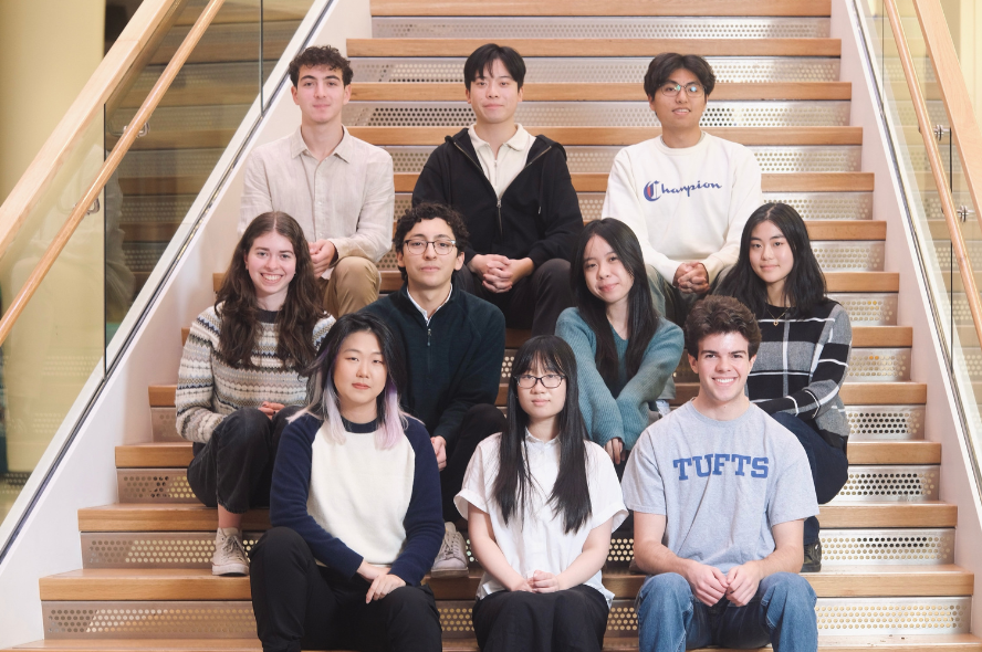 JumboCode team members are seated on staircase.