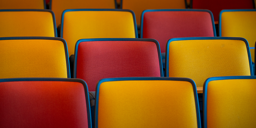 Yellow and red chairs in a lecture hall