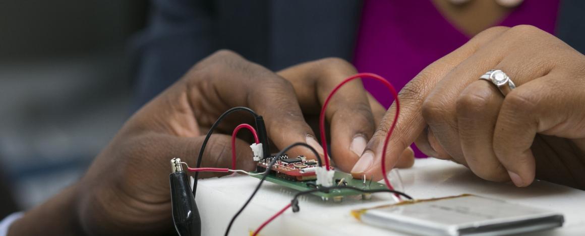 Valencia Joyner Koomson and a student discussing a circuit