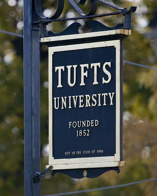 Tufts sign in front of a tree