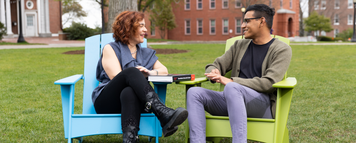 Professor Georgakoudi and biomedical engineering student Nilay Vora sit on colorful Adirondack chairs and chat amicably.