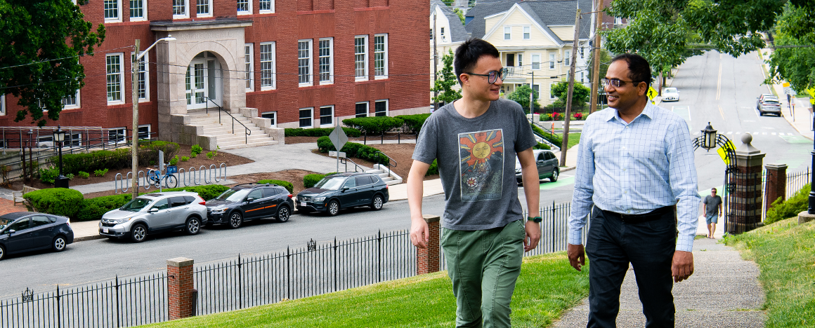 Wenxin Zeng and Sameer Sonkusale walking on a campus path