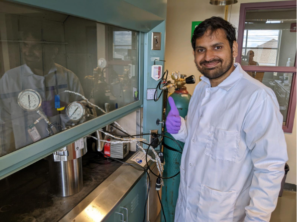 Ph.D. student Rishabh Chaudhary posing with the ultrasound instrument