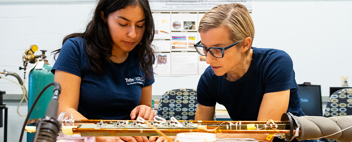 A professor and student work together in a lab.