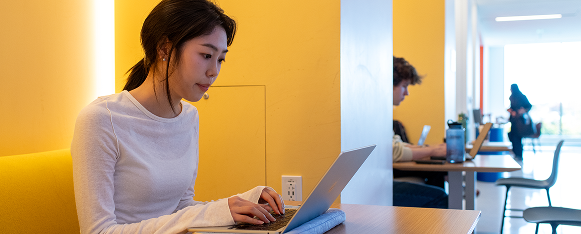 Students work at desks in the Joyce Cummings Center at Tufts University.