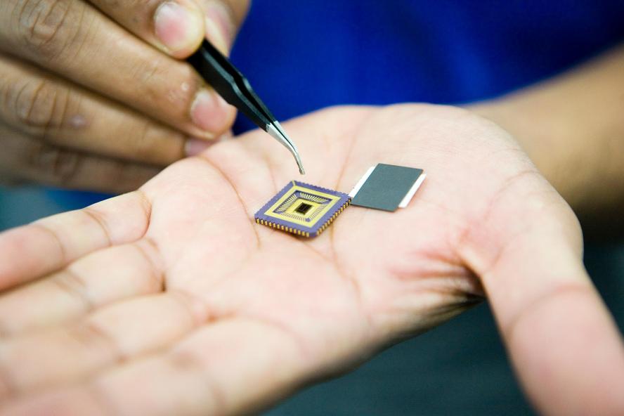 Closeup view of computer chip in engineer's hand