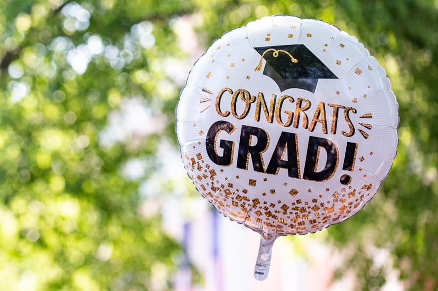 A balloon on campus displaying congrats grad!
