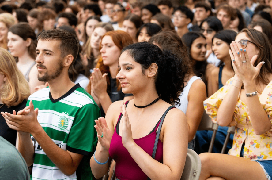 A crowd of students applaud at Tufts’ matriculation ceremony.