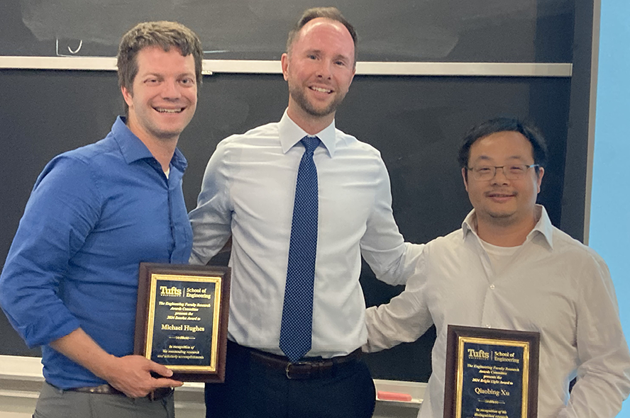 Professors Michael Hughes, Matthew Panzer, and Qiaobing Xu post with Hughes' and Xu's award plaques
