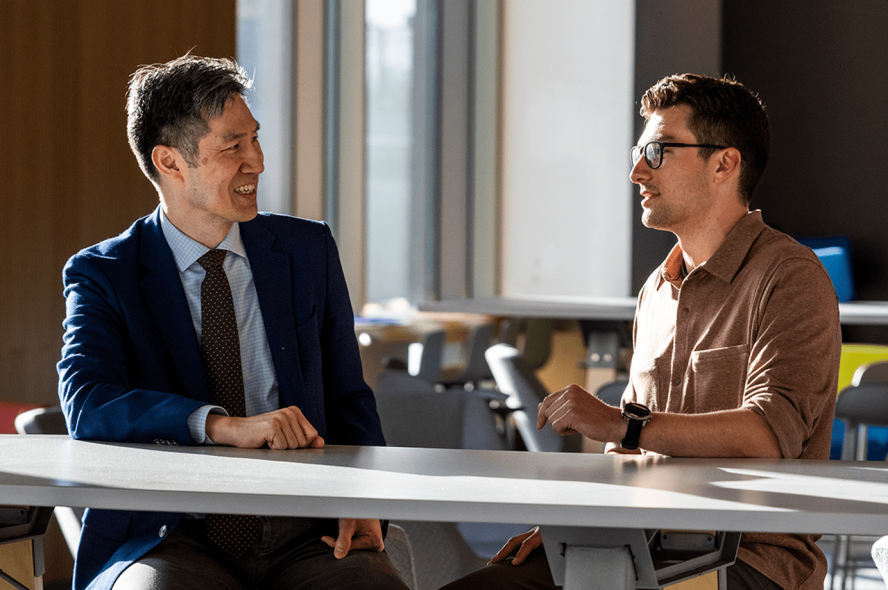 Dean Kyongbum Lee speaks with a student at Tufts University.