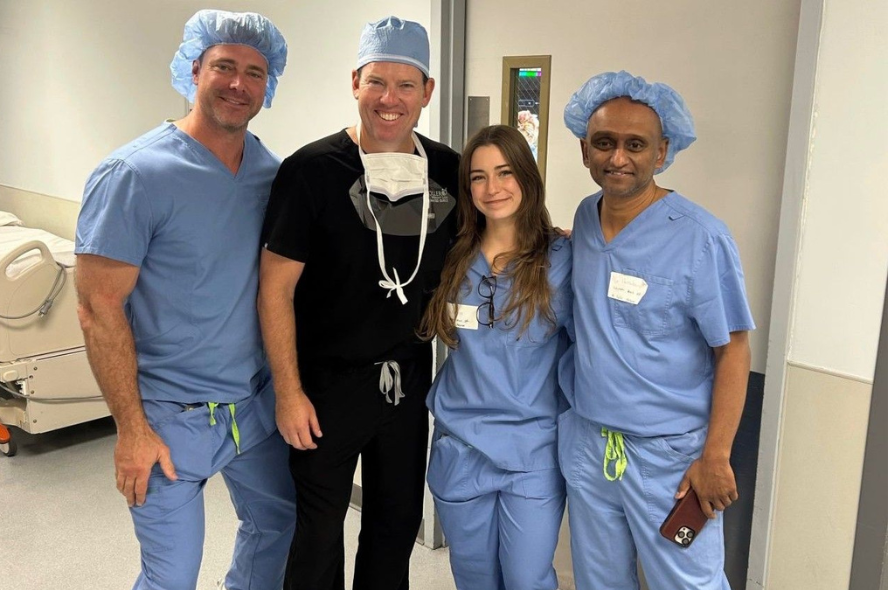 Bo Pilarczyk (second from right) with mentors at Lexington Medical Inc during a surgery observation. All four people in the photo are wearing scrubs.