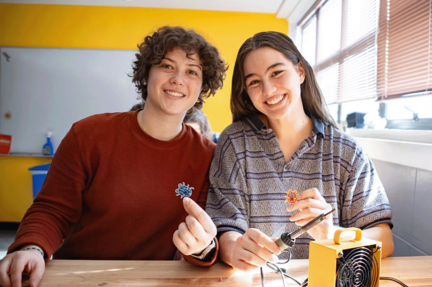Students build light-up beetles at an event
