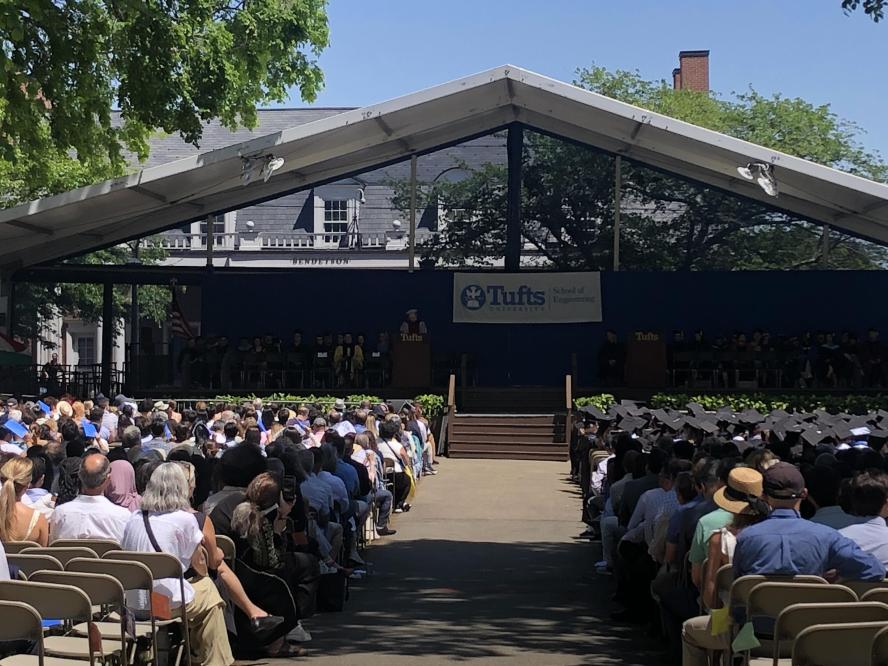 People gathered around commencement stage watching the ceremony