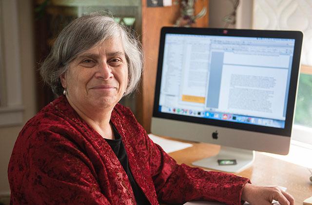Professor Susan Landau sits at her desk.