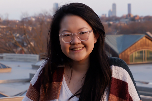 Kim Dao headshot, smiling, in front of Boston skyline
