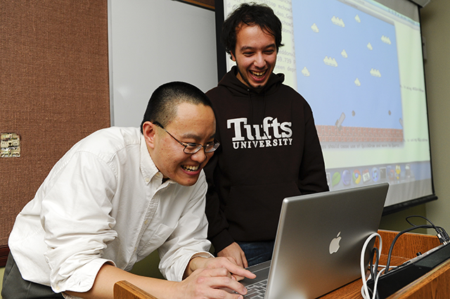 Senior Lecturer Ming Chow works with a student during a game development class.