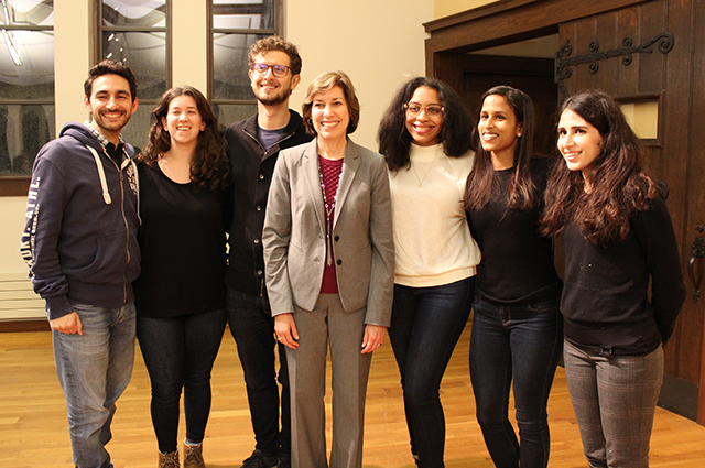 Tufts students pose for a photo, all smiling, with Dr. Ellen Ochoa in the center