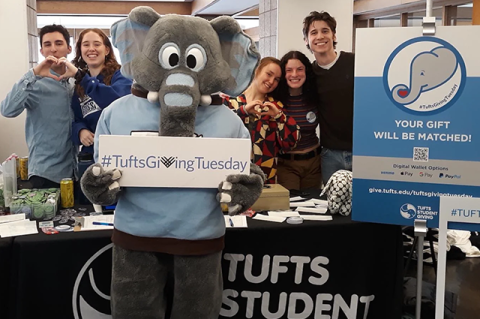 Jumbo the mascot joined students in Mayer Campus Center at the Tufts Student Giving table, where undergraduates put a lively and personal spin on philanthropy. Upbeat ambassadors for giving included (l-r) Ben Sagerian, A25 and Nina Houston, E23, (also making a pitch for a Ski Club challenge); and Gid Bennett, E25; Lori Donohoe, A24 and Cosmo Callaway, A26, who also raised awareness about a financial aid challenge to support the Climbing Club. Photo: Laura Ferguson