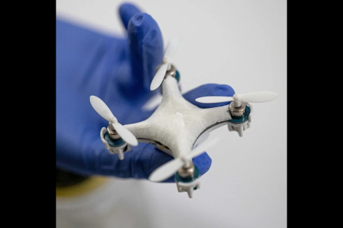 A small drone on a person’s gloved hand. Tufts engineers develop wearable, printable, shapeable biopolymer-based sensors detect pathogens and toxins in the environment