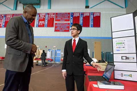 School of Engineering Associate Professor and Dean of Undergraduate Education Chris Swan speaks with Medford High School student Albert Farah during the 42nd Annual Region IV Science Fair at Somerville High School on March 10, 2018. Photo: Alonso Nichols