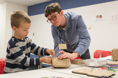 An undergraduate student helps an elementary schooler on a design project with Tufts CEEO.