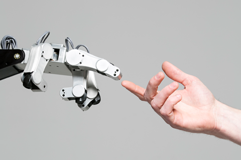 A close up of a robot hand reaching a finger out and almost touching a human hand in a recreation of Michelangelo's The Creation of Adam.