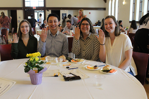 A group of students show off their ceremonial rings on the fifth finger of their working hand at the Order of the Engineer induction ceremony.