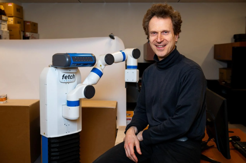 Karol Family Applied Technology Professor Matthias Scheutz with a robot in his lab.