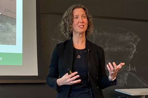 Dean Alexis Abramson delivers the 2024 spring Dean's Lecture for Tufts School of Engineering, speaking in front of a blackboard
