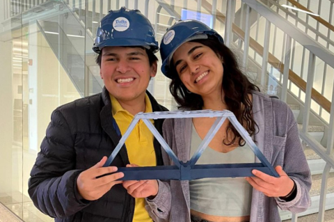 Dennis Bazan and Alyssa Dhalla holding their bridge.