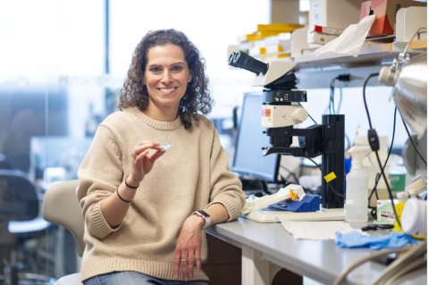 Gili Naveh, associate professor at both the School of Dental Medicine and the School of Engineering, in. her lab on the Medford/Somerville campus with her cavity-detecting device, the CaviSense. Photo: Alonso Nichols