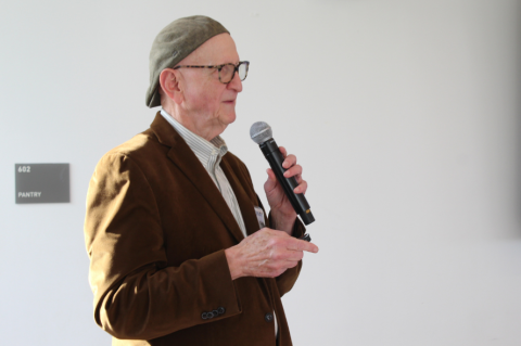 Professor Jonathan Garlick, holding a microphone and speaking. 