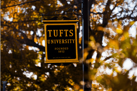 A Tufts University sign on campus in the fall