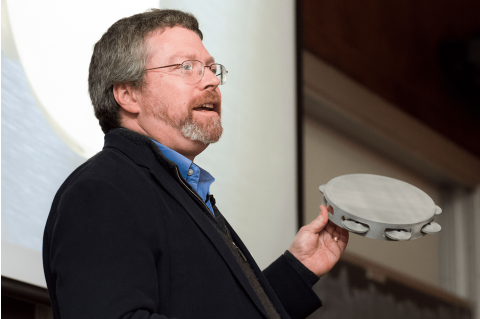 Keith Moore delivers the Dean's Lecture, 3D-printed tambourine in hand
