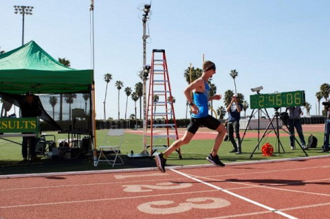 Tyler Andrews running on a track