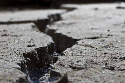 Close-up of a crack in a concrete road.