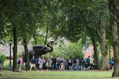 Students walk past the Jumbo the elephant statue