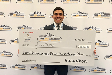 A man holding a large check