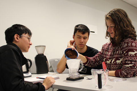 Students in Coffee Engineering pour grounds into filter