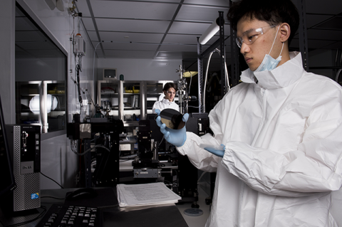 Students pose for a portrait at a work station in the REAP Lab 