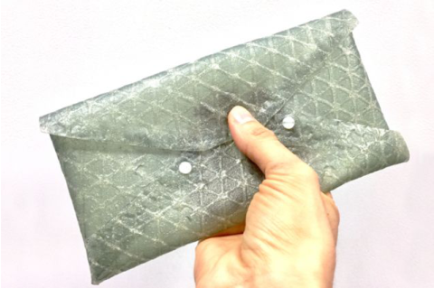A small clutch purse demonstrates the utility of silk leather in manufacturing products