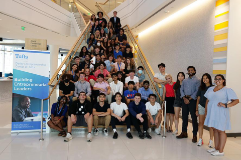 Pre-college cohort sitting on the stairs at Joyce Cummings Center