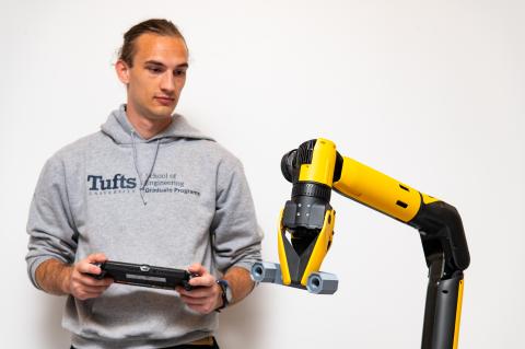 Chris Thierauf, a third-year doctoral candidate in Computer Science, interacts with a Boston Dynamics robot in the Human Robot Interaction Laboratory