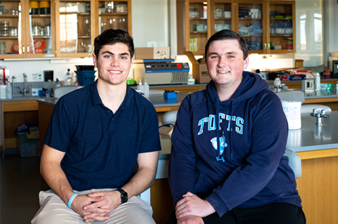 Undergraduates in biomedical engineering Patrick Solomon, E24, and Andrew Langley, E23, sit side by side at a lab bench.