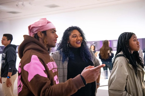 Grace Caldera, center, director of the Center for STEM Diversity, reacts as CJ Burton, A26, makes an observation during a visit to an exhibition at the Tufts University Art Gallery on March 30. Photo: Alonso Nichols